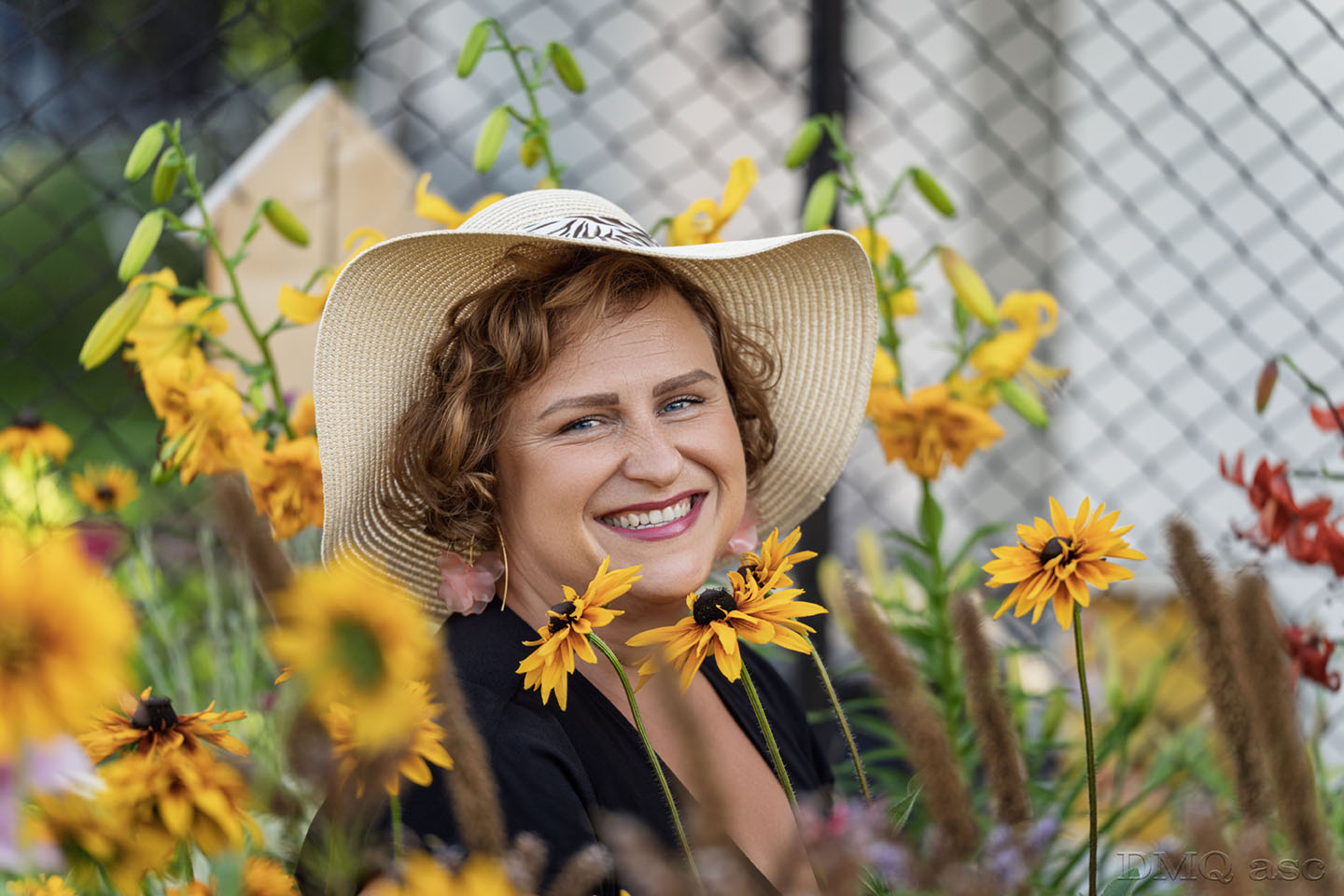 Portrait Photo. Girl hidden in sunflowers.